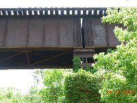 close-up of side of bridge and top of column