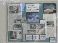A collage of news articles posted on the wall by the front door.