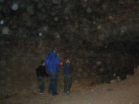 if you ignore the dust orbs, you can see sparkly dots on the cave wall - even way above my brother's head. Those are hundreds of tealight candles which are lining the walls on both sides of the chamber