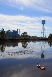 The new factory and current waste pond.